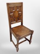 An Edwardian panelled oak hall chair