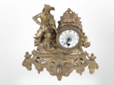 A gilt metal figural mantel clock with enamel dial, height 29cm.