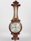 An oak barometer with silvered dial, signed J. Durkin, Middlesbrough, length 83cm.