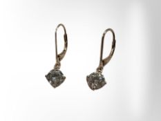 A pair of silver earrings set with cz