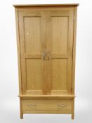 A contemporary solid oak double door wardrobe,