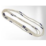 Two long strands of pearls with lapis lazuli and gold beads