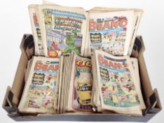 A box containing vintage Beano, Tiger and Marvel comics.