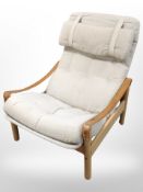 A 20th century Danish beech framed armchair with tan leather sling arm rests