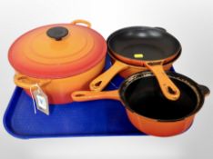 A Le Creuset twin-handled lidded casserole dish, together with four further Le Creuset pans.