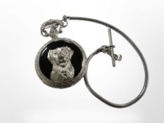A pocket watch and chain with dog head motif