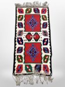 A small Eastern fringed kilim, 90cm x 40cm.