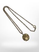 A Victorian gold-plated locket on yellow metal chain.