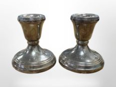 A pair of loaded silver dwarf candlesticks, height 6cm.
