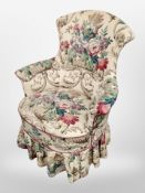 An early 20th century armchair in floral upholstery