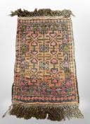 A small Afghan hearth rug, 76cm x 40cm.