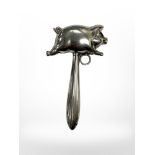 A silver plated rattle in the form of a pig