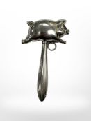 A silver plated rattle in the form of a pig