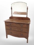 An Edwardian oak three drawer mirror backed dressing chest,
