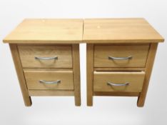 A pair of contemporary solid oak two drawer bedside chests,