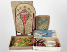 A box of vintage tin plate toys including bagatelle board, remote control helicopter, etc.