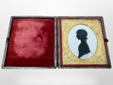 An early Victorian silhouette portrait in tooled leather case, dated 1841.