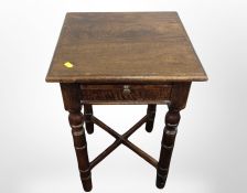 A reproduction oak bedside table fitted with a drawer,