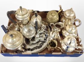 A box of brass and silver-plated tea wares.