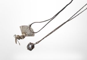 A silver fan pendant on chain, and a further rose pendant.