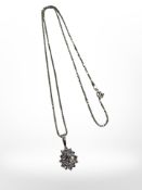 A silver pendant and chain