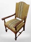 An early 20th century Danish oak open armchair in striped upholstery,
