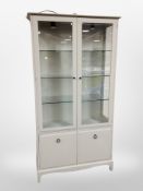 A contemporary painted double door display cabinet,