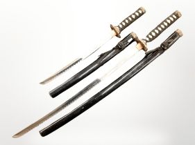 Two reproduction Japanese swords in scabbards.