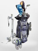 A golf bag and trolley containing assorted irons and drivers, including Cobra, Callaway, etc.