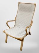 A 20th century Danish beech framed armchair with canvas webbing seat