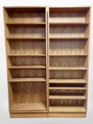 A pair of 20th century teak open bookcases with adjustable shelves,