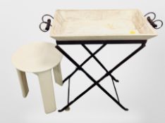 A wooden twin handled tray on folding metal stand and a Scandinavian plastic tripod table