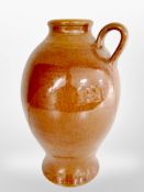 A glazed earthenware wine jug, height 41cm.