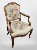 A Continental carved beech salon chair in needlework upholstery
