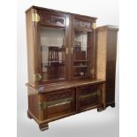 An early 20th century mahogany brass mounted bookcase on stand,