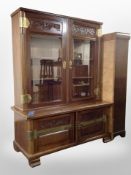 An early 20th century mahogany brass mounted bookcase on stand,