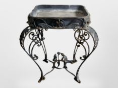A wrought metal lead lined planter,