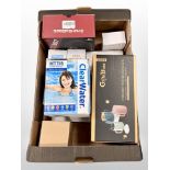A box of new retail stock items - Drink water bottles, gaming headphones,