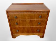 A 1930's walnut veneered three drawer chest,