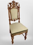 A 19th century heavily carved beech hall chair with armorial crest flanked by two dragons