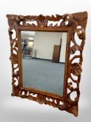 A carved beech framed mirror,