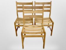 Three 20th century oak framed ladder backed chairs