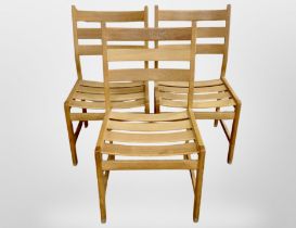 Three 20th century oak framed ladder backed chairs