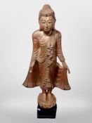 A Thai gilt wood figure with 'jewelled' decoration, on ebonised plinth,
