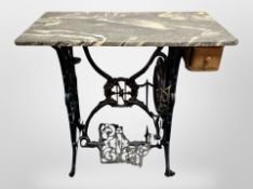 A cast iron sewing machine treadle base with later marble top CONDITION REPORT: