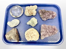 A group of geodes including amethyst and a crystal paperweight.
