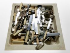 A plastic tray of assorted stainless steel and EPNS cutlery.