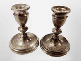 A pair of loaded silver candlesticks, height 12cm.