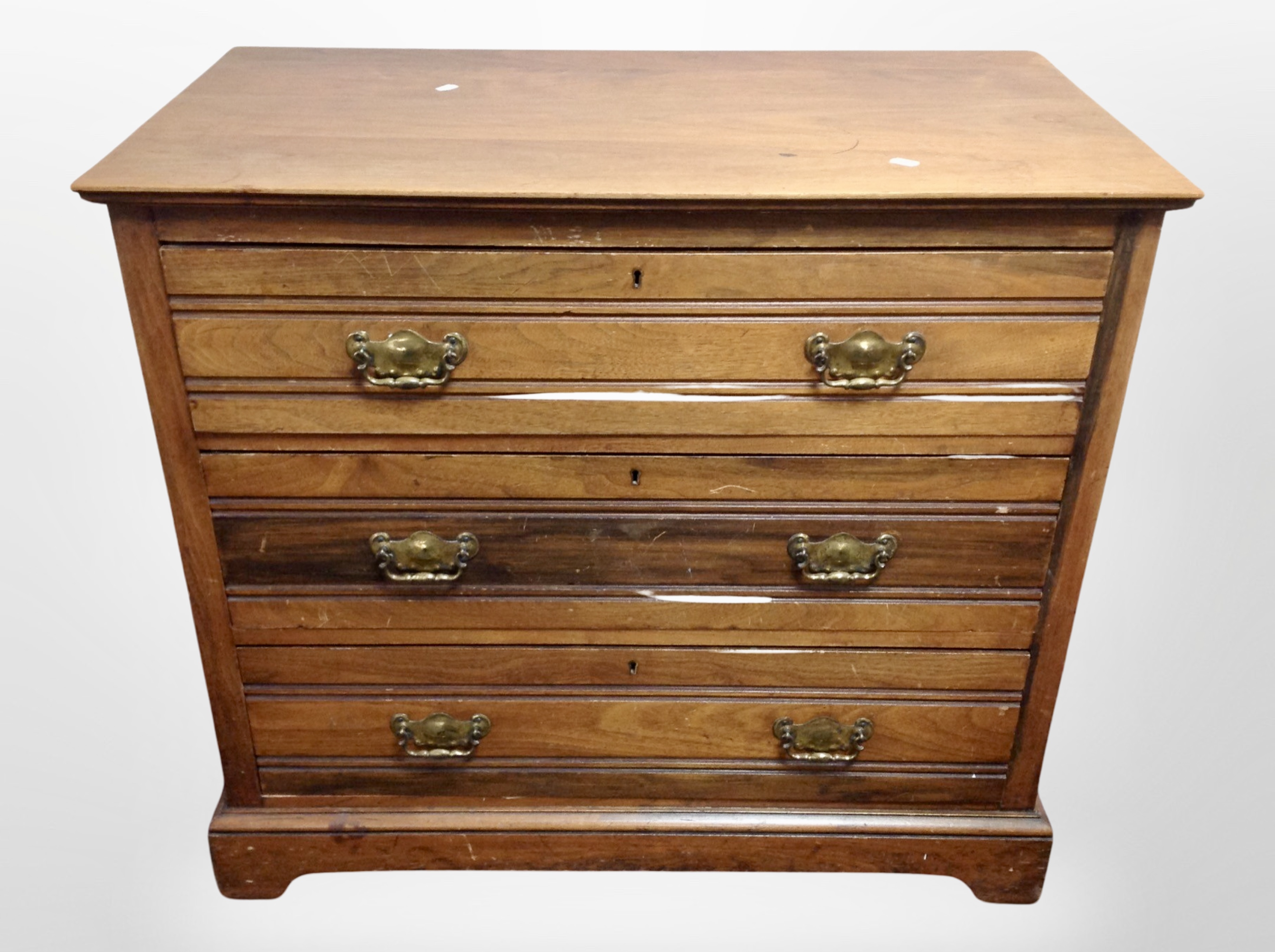 A late Victorian walnut three drawer chest,