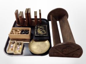 An Edwardian carved oak book trough, together with a pair of bookends, a boxwood chess set,